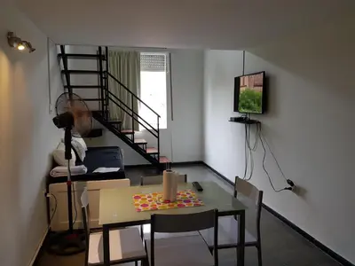 a room with a table with a candle on it at Departamento Loft VCP in Villa Carlos Paz
