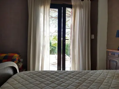 a bedroom with a bed and a large window at Hermosa casa en Potrero de Garay in Potrero de Garay