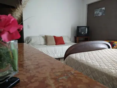 a living room with a couch and a tv at Hermosa casa en Potrero de Garay in Potrero de Garay