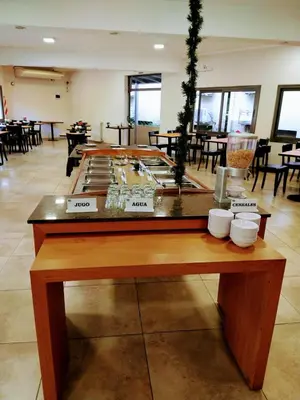 a table in a room with tables and chairs at Hotel Hurlingham in Villa Carlos Paz