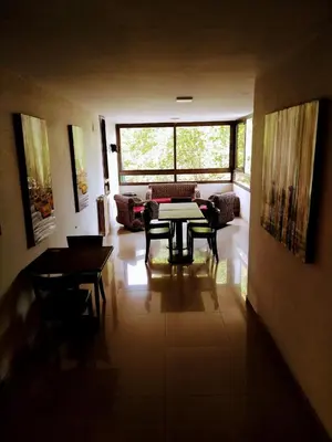 a living room with a table and a couch at Hotel Hurlingham in Villa Carlos Paz