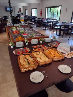a table with many different types of food on it at Hotel Hurlingham in Villa Carlos Paz