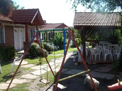 a swing set in the yard of a house at Complejo Sagrado Corazón in Merlo