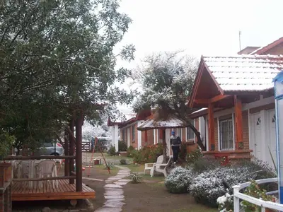 a person standing in a yard next to a house at Complejo Sagrado Corazón in Merlo