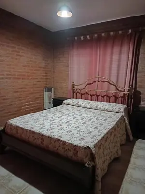 a bedroom with a large bed in a room at casa villa suiza in Villa Carlos Paz