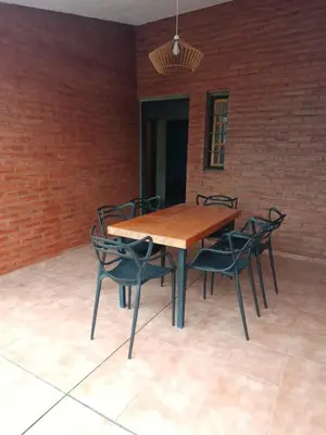 a wooden table and chairs in a room at casa villa suiza in Villa Carlos Paz
