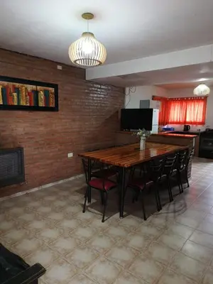 a dining room with a wooden table and chairs at casa villa suiza in Villa Carlos Paz