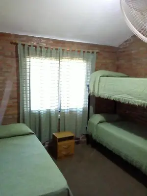 a bedroom with two bunk beds and a window at casa villa suiza in Villa Carlos Paz