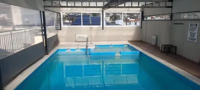 a swimming pool in a building with blue water at Dpto centrico in Villa Carlos Paz