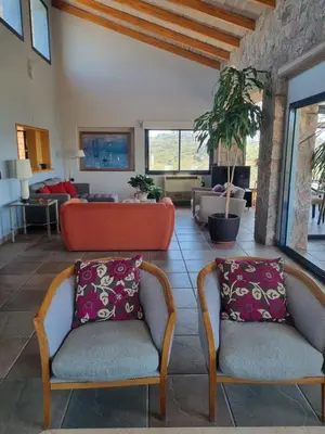 a living room with two chairs and a couch at casa del lago -villa carlos paz in Villa Carlos Paz