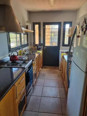 a kitchen with a sink and a stove top oven at casa del lago -villa carlos paz in Villa Carlos Paz