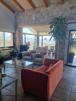 a living room with a couch and a table at casa del lago -villa carlos paz in Villa Carlos Paz