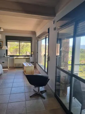 a bathroom with a chair in the middle of a room at casa del lago -villa carlos paz in Villa Carlos Paz