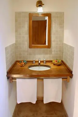 a bathroom with a sink and a mirror at Cabañas Am Bach in Villa General Belgrano
