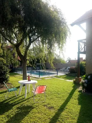 a table and two chairs sitting in a yard at Cabañas Euzkadi in Merlo