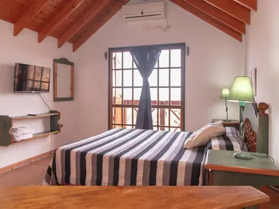 a bedroom with a bed and a window at Cabañas Euzkadi in Merlo