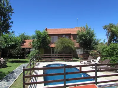 a house with a swimming pool in front of a house at Chalet Individual Maiten 2 in Merlo