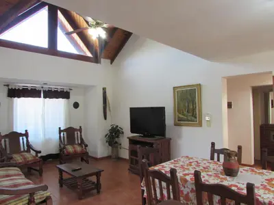 a living room with a table and a tv at Chalet Individual Maiten 2 in Merlo