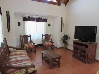 a living room with chairs and a flat screen tv at Chalet Individual Maiten 2 in Merlo