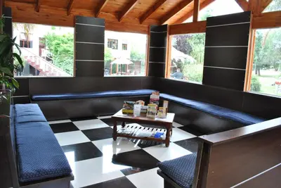 a bar with black walls and a checkered floor at Cana Blaya Apart Hotel in Merlo