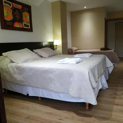 a bedroom with a bed with towels on it at Cana Blaya Apart Hotel in Merlo
