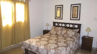 a bedroom with a bed and a window at Cabanas los lirios in Santa Rosa de Calamuchita