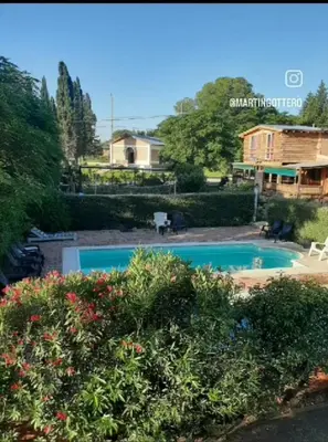 a swimming pool in a yard with a house at Cabañas Kehuen in Villa Amancay