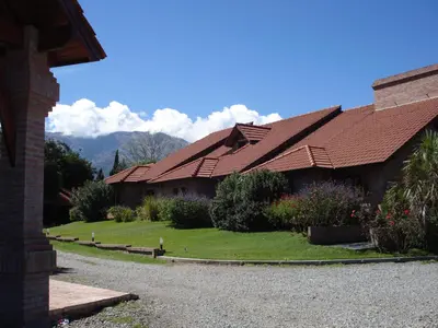 a house with a pitched roof with a yard at Villa de Merlo All Inclusive & Spa by MH in Merlo