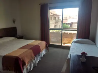 a hotel room with two beds and a large window at Villa de Merlo All Inclusive & Spa by MH in Merlo