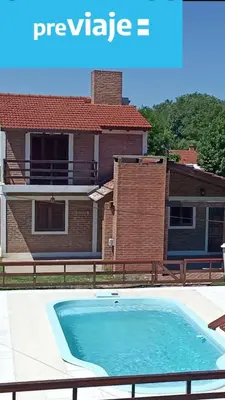 a house with a swimming pool in front of a house at La Herradura in Santa Rosa de Calamuchita