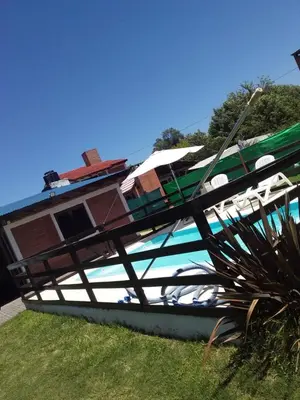 a boat sitting on the grass in front of a house at La Herradura in Santa Rosa de Calamuchita