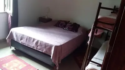 a small bedroom with a bed and a ladder at La Herradura in Santa Rosa de Calamuchita