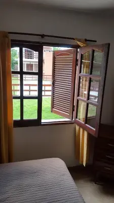 a bedroom with a window with a view of a yard at La Herradura in Santa Rosa de Calamuchita
