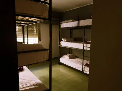 a room with four bunk beds and a window at Lacandona Hostel in Cordoba