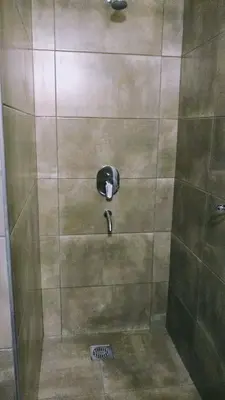 a shower with a faucet in a bathroom at Cabañas El Descanso in Villa Carlos Paz