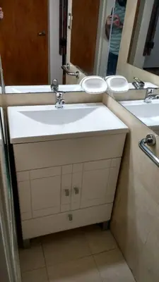 a bathroom with two sinks and a mirror at Cabañas El Descanso in Villa Carlos Paz
