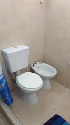 a bathroom with a white toilet and a bidet at Cabañas El Descanso in Villa Carlos Paz