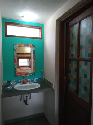 a bathroom with a sink and a mirror at Cabaña El Mirador de Bialet Masse in Villa Parque Siquiman