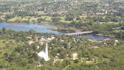 an aerial view of a town next to a river at Cabaña El Mirador de Bialet Masse in Villa Parque Siquiman