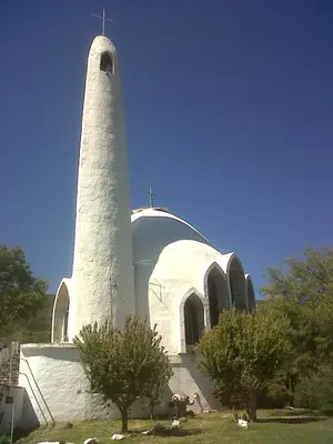 a white building with a lighthouse on top of it at Cabaña El Mirador de Bialet Masse in Villa Parque Siquiman