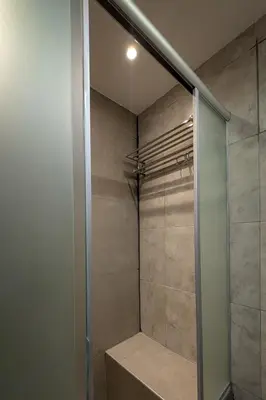 a walk in shower with a glass door at Aldea Hostel & Café in Cordoba