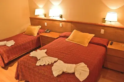 a hotel room with two beds with bows on them at Hotel Felipe II in Cordoba