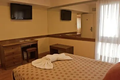 a bedroom with a bed with a towel on it at Hotel Felipe II in Cordoba