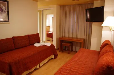 a hotel room with a couch and a table at Hotel Felipe II in Cordoba