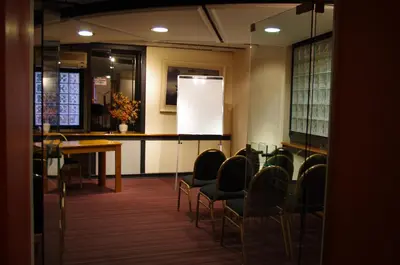 a room with chairs and a table and a whiteboard at Hotel Felipe II in Cordoba