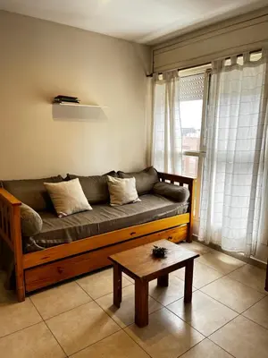 a living room with a couch and a coffee table at El Abrojal - Departamento con Estacionamiento , zona Patio Olmos in Cordoba