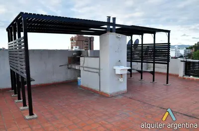 a building with a roof with a metal structure at Serena in Villa Carlos Paz