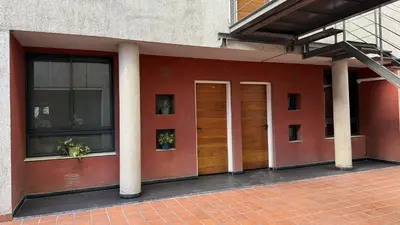 a building with two doors on the side of it at Serena in Villa Carlos Paz