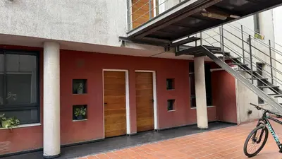 a bike parked on a sidewalk next to a building at Serena in Villa Carlos Paz