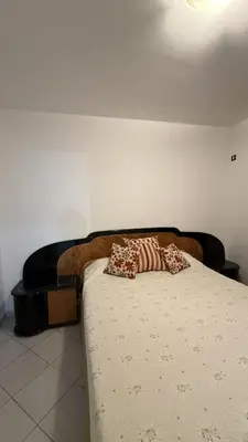 a bed with two pillows on it in a room at Serena in Villa Carlos Paz